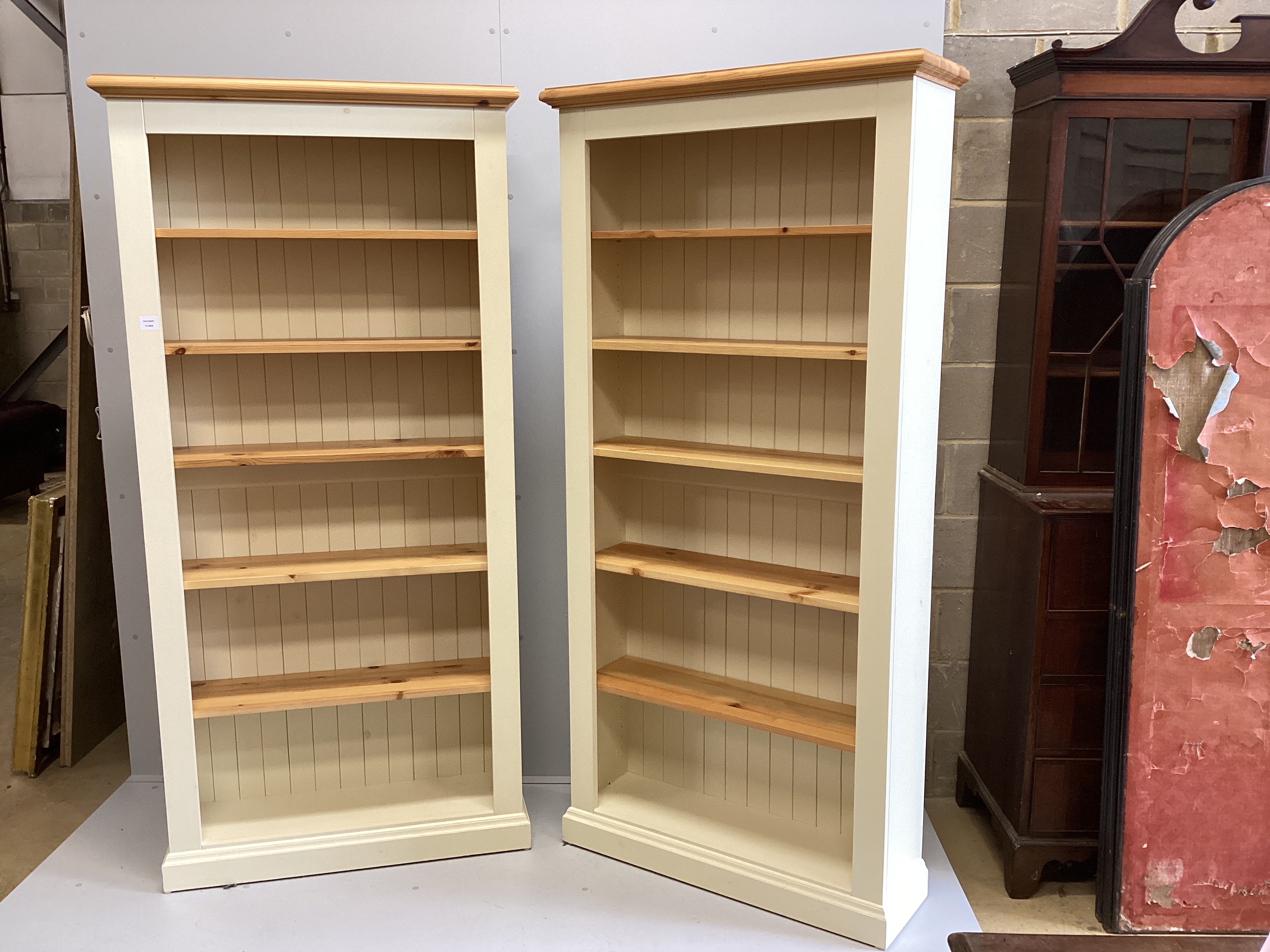 A pair of modern cream painted tall pine open bookcases with adjustable shelves, width 96cm, depth 30cm, height 198cm